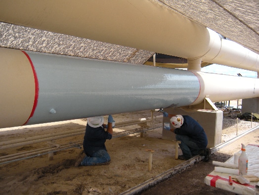 HydraLine being applied to a pipe by two field services technicians