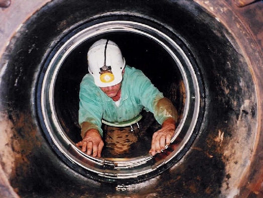 A field services technician installing HydraWrap in a small diameter pipe