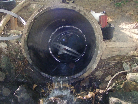 multiple seals being installed in a small diameter pipe by field services technicians