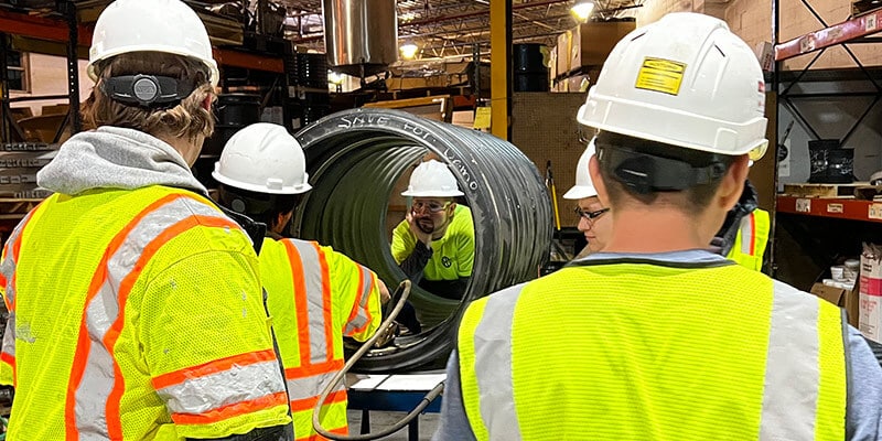 technicians installing HydraTite in a test pipe