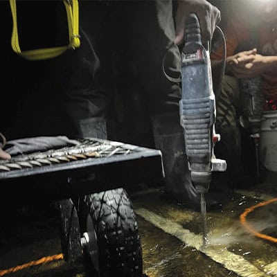 Drilling holes for the anchors used during the HydraTite installation