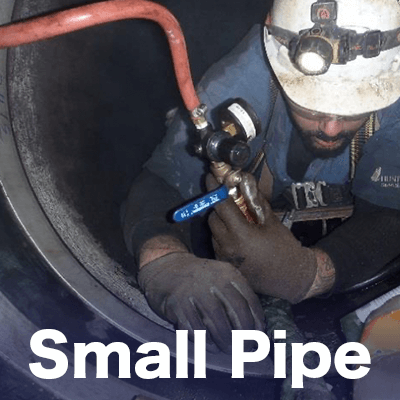 Close up of a technician inside a pipe installing HydraTite, 'Small Pipe'