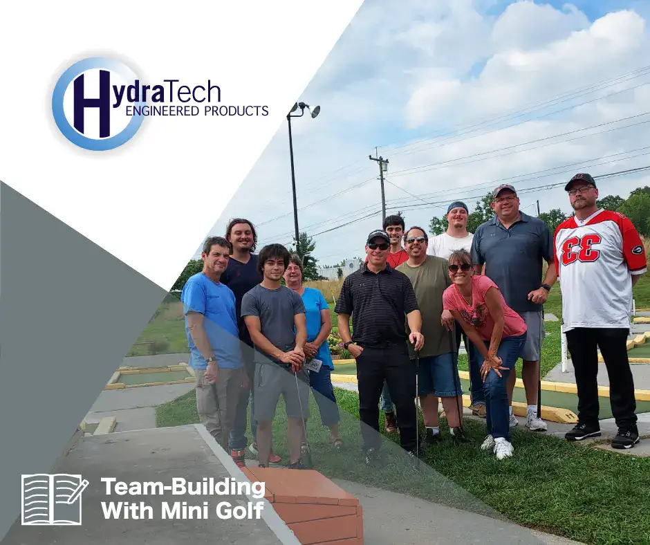 HydraTech all standing in front of a mini golf course, 'Team Building With Mini Golf'