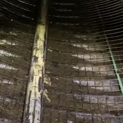 A hole rusted out of a corrugated pipe