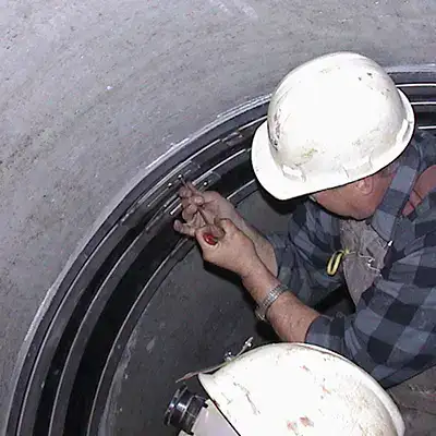 Retaining bands sitting at the invert of a pipe near the joints