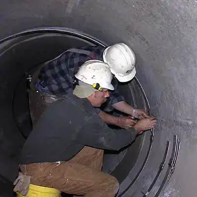 Retaining bands sitting at the invert of a pipe near the joints