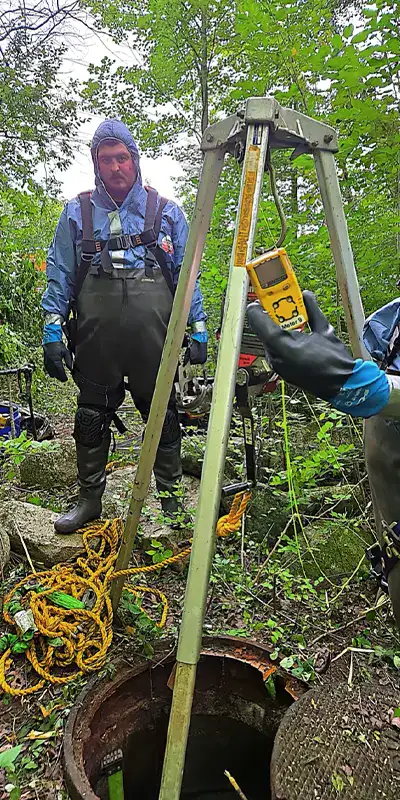 Joint with an active leak in a green PVC pipe