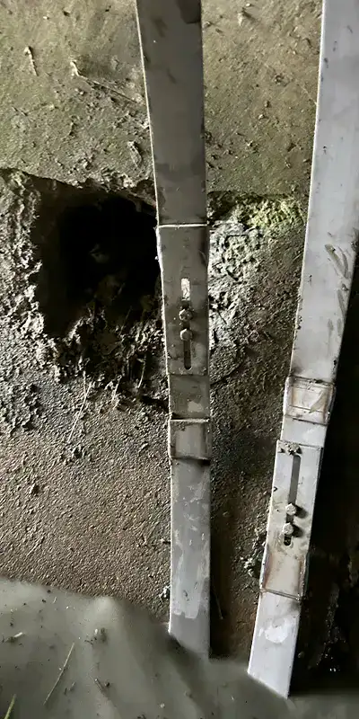 Joint with an active leak in a green PVC pipe