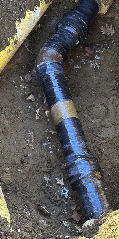 New concrete poured around the base of a pavilion post. A lower portion of the post has been reinforced with HydraWrap