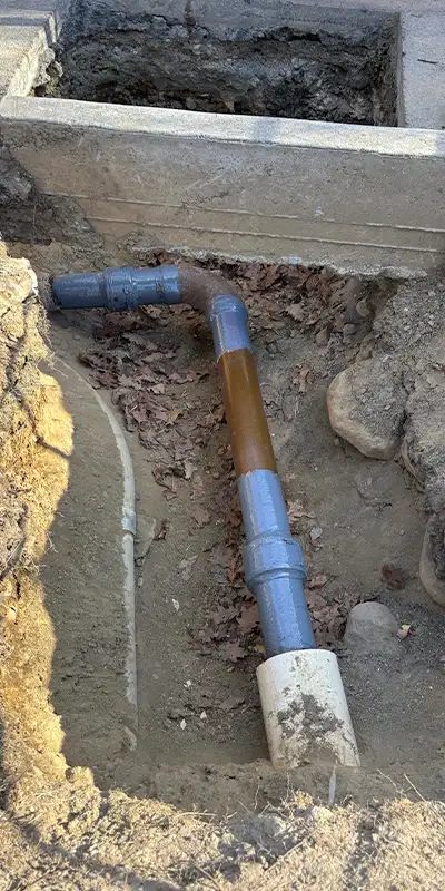 New concrete poured around the base of a pavilion post. A lower portion of the post has been reinforced with HydraWrap