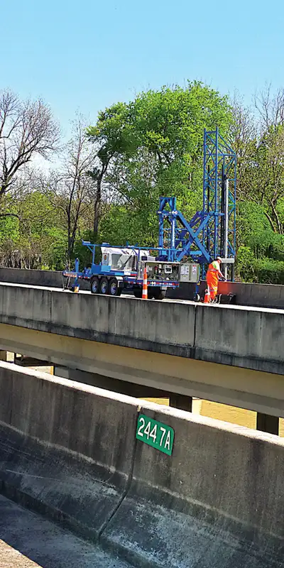A-lift-being-used-to-repair-supports-under-a-bridge Two HydraTite Installers