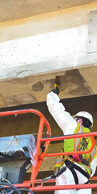 A-technician-applying-apoxy-to-a-bridge-support Two HydraTite Installers