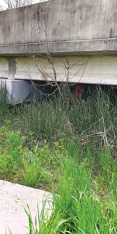 A-technician-tucked-away-under-a-bridge Two HydraTite Installers