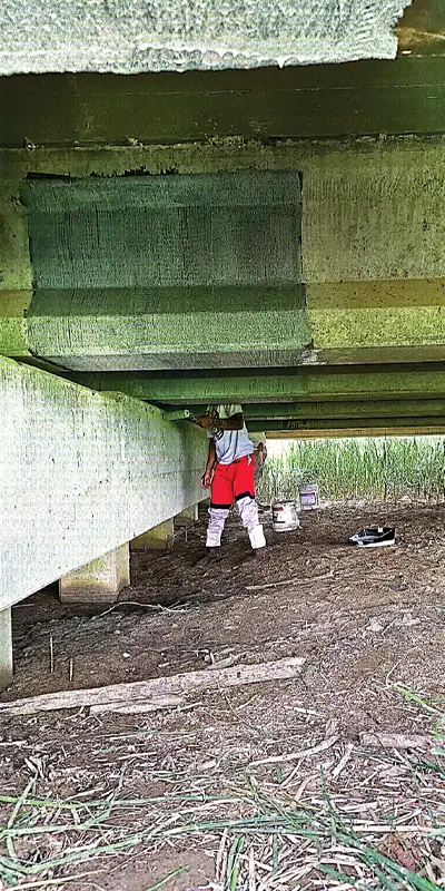 Applying-carbon-fiber-fabric-to-the-underside-of-a-bridge Two HydraTite Installers