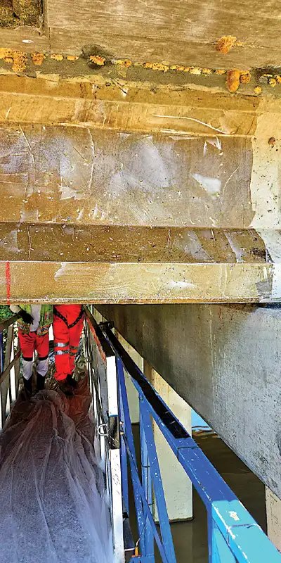 Epoxy-applied-to-a-bridges-support Two HydraTite Installers