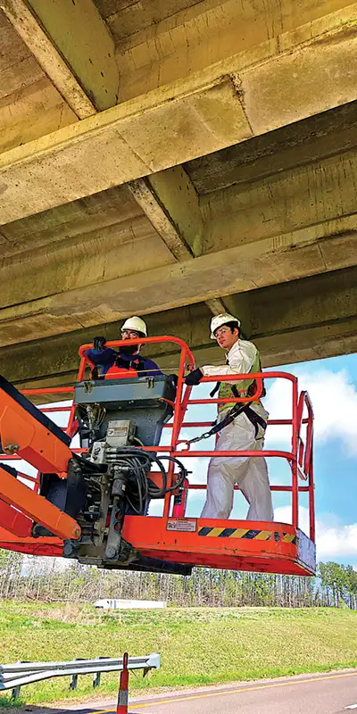 Two-technicians-in-a-lift-preparing-to-repair-a-bridge Two HydraTite Installers