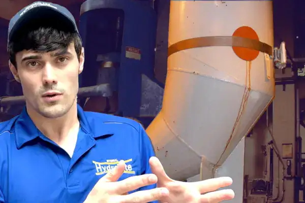 Guy sitting in front of a reducing elbow that is leaking