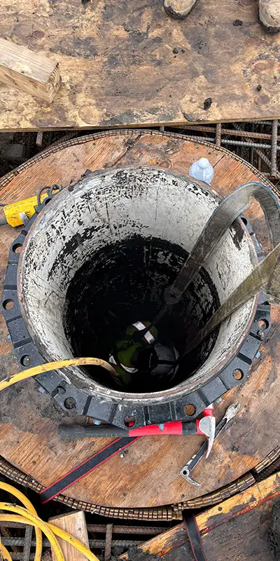 A-Technician-Deep-In-A-Small-Diameter-Pipe Retaining bands loosely placed over a rubber seal