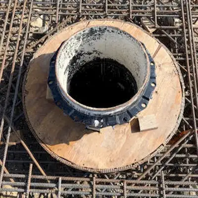 Two technicians installing HydraTite in a large diameter pipe