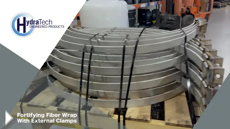 Fortifying External Clamps1 A stack of steel on a shipping pallet, 'Fortifying Fiber Wrap With External Clamps"