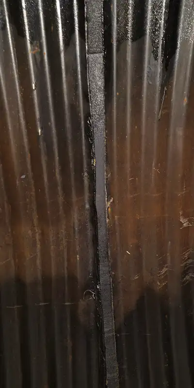 Two technicians installing HydraTite in a round pipe