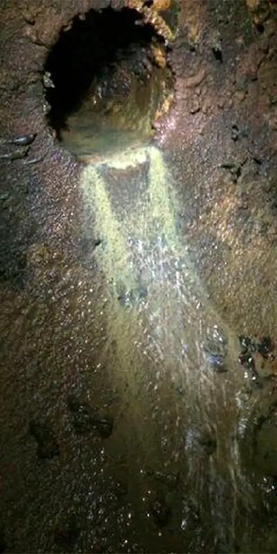 Two technicians installing HydraTite in a round pipe