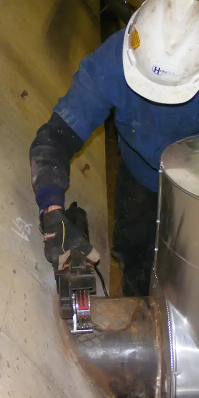 New concrete poured around the base of a pavilion post. A lower portion of the post has been reinforced with HydraWrap