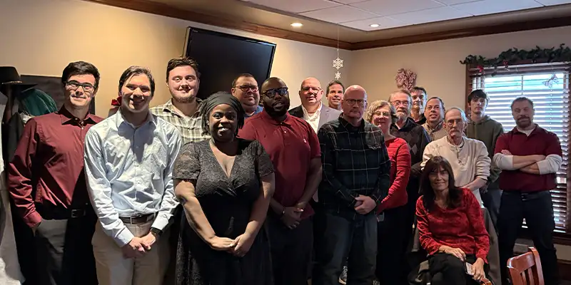 two people sitting at a trade show booth