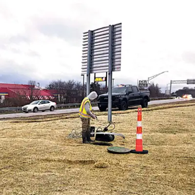 A technician standing watch near a pipe entry point